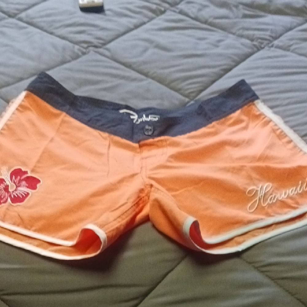 Vibrant Orange Athletic Shorts with Hibiscus Design